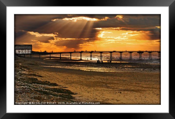 Silhouettes on a sunset beach Framed Mounted Print by ROS RIDLEY