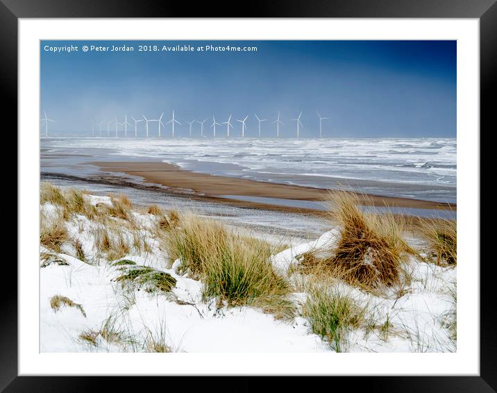 Cold conditions on a deserted beach with snowy cli Framed Mounted Print by Peter Jordan