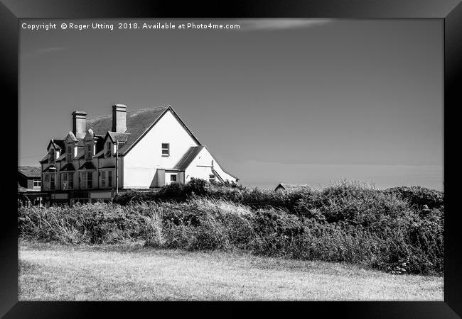 Shops on the cliff Framed Print by Roger Utting