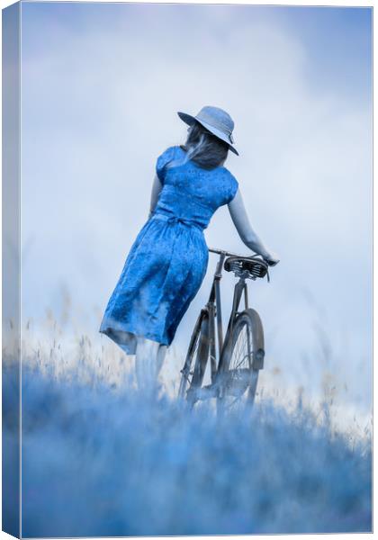 woman with bicycle in field Canvas Print by Maggie McCall