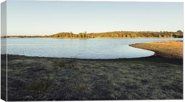 Sunny lake with eucalyptus mountain in the backgro Canvas Print by Juan Ramón Ramos Rivero