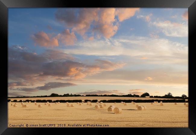 Norfolk hay bales basking in the sunset glow Framed Print by Simon Bratt LRPS