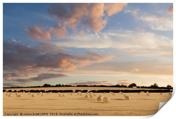 Norfolk hay bales basking in the sunset glow Print by Simon Bratt LRPS