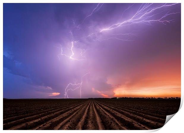 Lightning crawler over a ploughed field at sunset Print by John Finney
