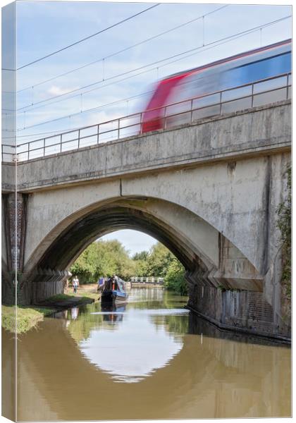 Train crossing canal Canvas Print by Graham Custance