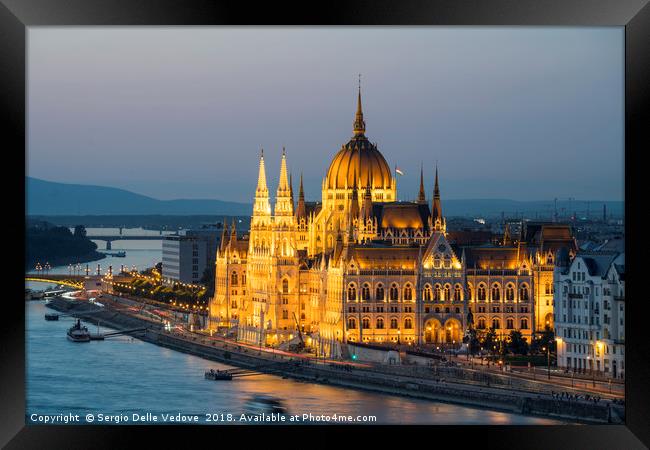 Parliament building at sunset in Budapest. Framed Print by Sergio Delle Vedove