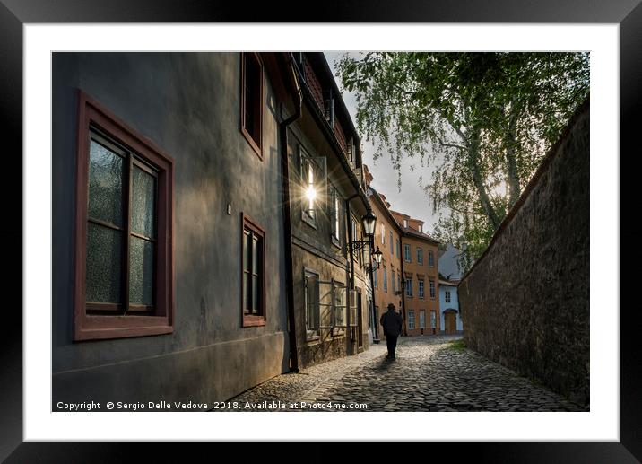 A man walking in Mala Strana  district in Prague,  Framed Mounted Print by Sergio Delle Vedove