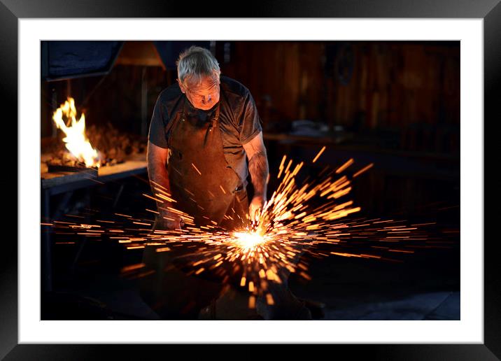 Blacksmith hammering red hot iron Framed Mounted Print by Johan Swanepoel