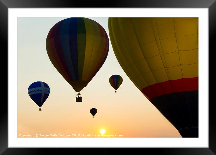 Balloons flying at the sunset Framed Mounted Print by Sergio Delle Vedove
