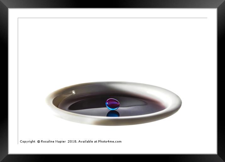 Colourful water droplet balancing on cup of water Framed Mounted Print by Rosaline Napier