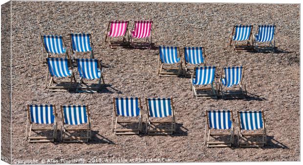 Deck chairs on the beach Canvas Print by Alan Tunnicliffe