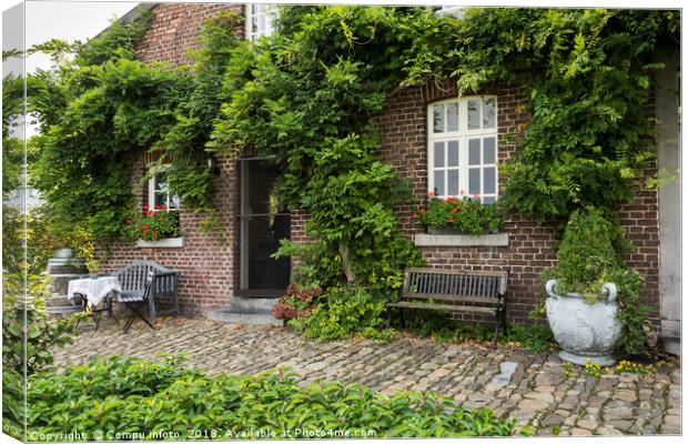 old farm with green plants on the wall Canvas Print by Chris Willemsen