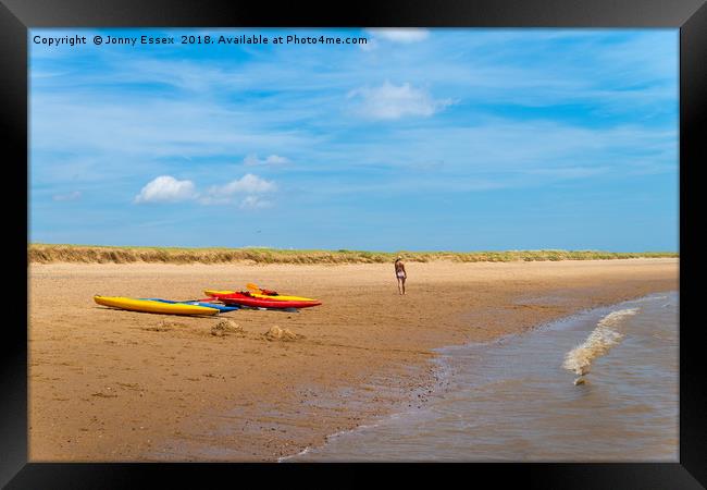 A stroll along the beach past some kayaks, canoes Framed Print by Jonny Essex