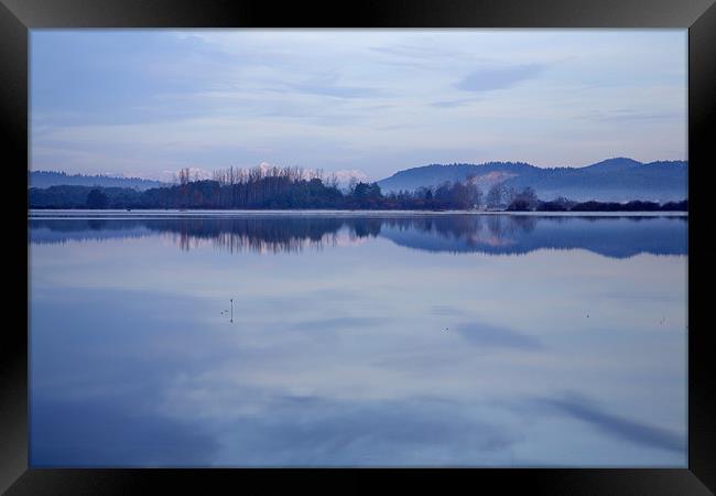 Cerknica lake at dawn with snow covered alps Framed Print by Ian Middleton