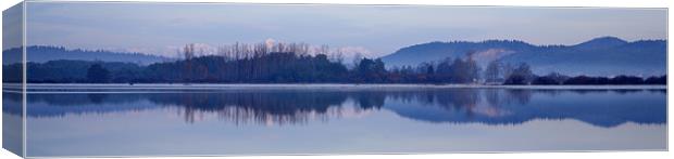 Cerknica lake at dawn with snow covered alps Canvas Print by Ian Middleton