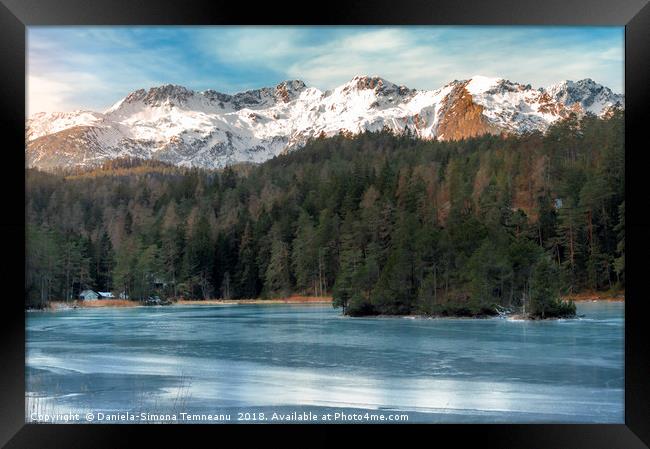 Frozen lake and snow-capped mountains Framed Print by Daniela Simona Temneanu
