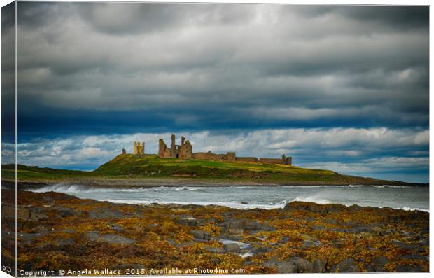 Dunstanburgh Castle on a blustery day Canvas Print by Angela Wallace