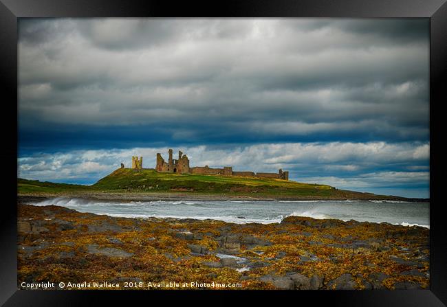 Dunstanburgh Castle on a blustery day Framed Print by Angela Wallace
