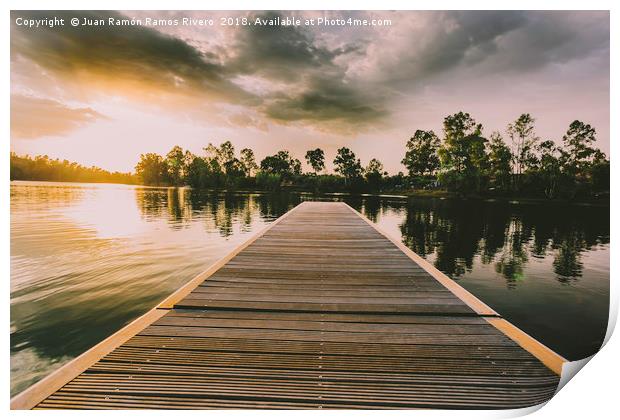 Wooden jetty over the lake at sunset in a sky with Print by Juan Ramón Ramos Rivero