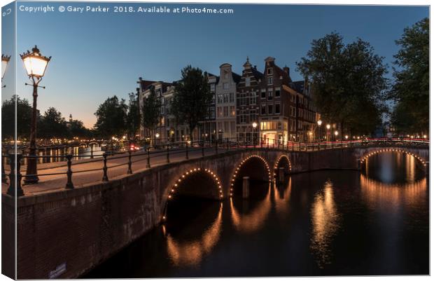 Amsterdam canal and bridge, at dusk.  Canvas Print by Gary Parker