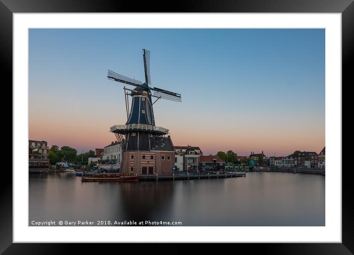 Dutch windmill, in the town of Haarlem, at sunset. Framed Mounted Print by Gary Parker