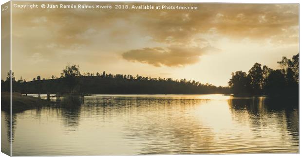 Sunset over the lake with sunlight illuminating Canvas Print by Juan Ramón Ramos Rivero