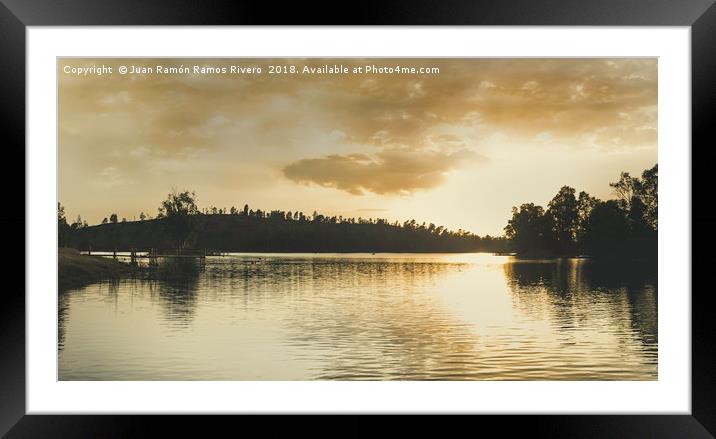 Sunset over the lake with sunlight illuminating Framed Mounted Print by Juan Ramón Ramos Rivero