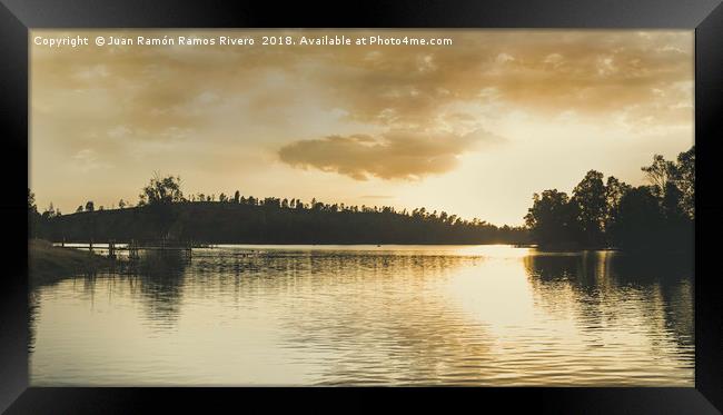 Sunset over the lake with sunlight illuminating Framed Print by Juan Ramón Ramos Rivero