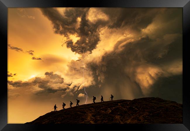 Hikers on the storm Framed Print by John Finney