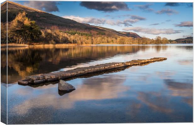 The old stone jetty on the shore of a very still L Canvas Print by George Robertson