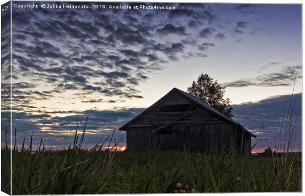 Midsummer Sun Sets Behind An Old Barn House Canvas Print by Jukka Heinovirta