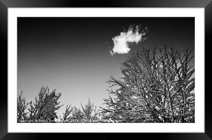 A cloud in the sky in winter Framed Mounted Print by Sergio Delle Vedove