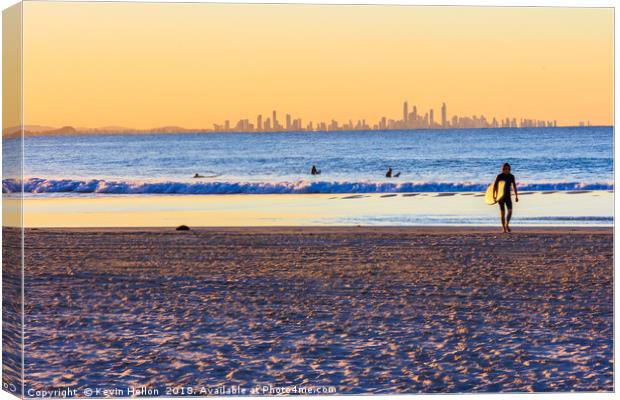 Surfer walks away from the sea  Canvas Print by Kevin Hellon