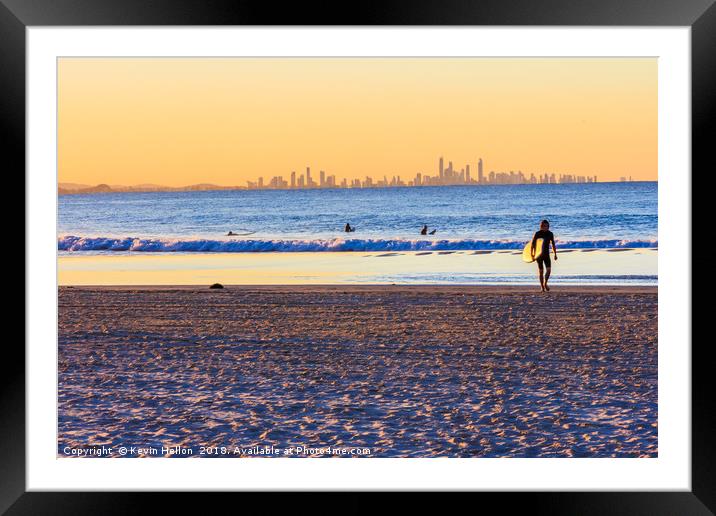 Surfer walks away from the sea  Framed Mounted Print by Kevin Hellon