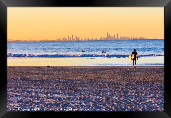 Surfer walks away from the sea  Framed Print by Kevin Hellon