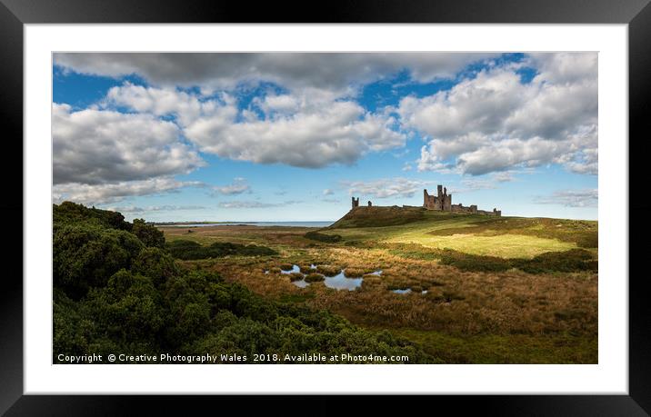 Dunstanburgh Castle on the Northumberland Coast Framed Mounted Print by Creative Photography Wales
