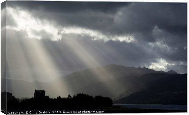 Crepuscular rays over Eilean Donan Castle Canvas Print by Chris Drabble