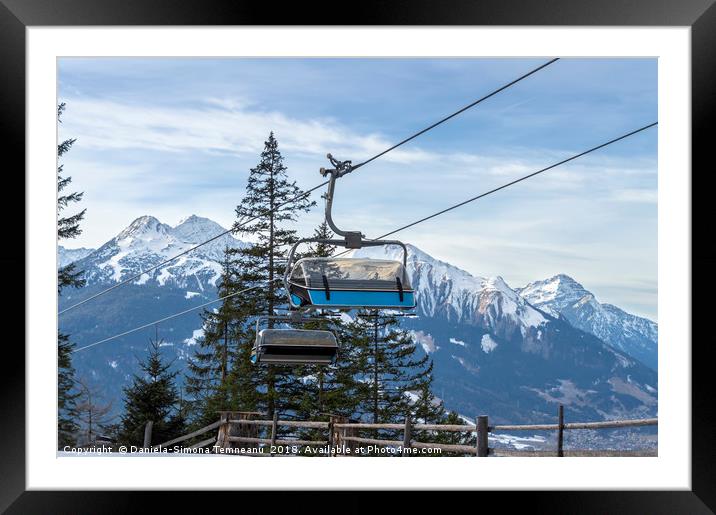Ski lift with the snowy mountain in the background Framed Mounted Print by Daniela Simona Temneanu