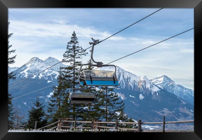 Ski lift with the snowy mountain in the background Framed Print by Daniela Simona Temneanu