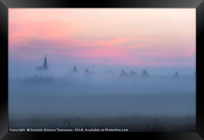 Church tower and village in fog at dawn Framed Print by Daniela Simona Temneanu