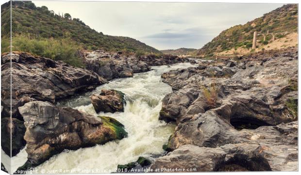 Rapids of the river with rock covered with moss Canvas Print by Juan Ramón Ramos Rivero