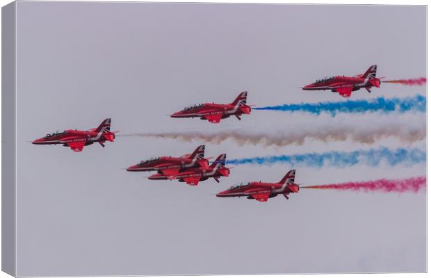 Red Arrows with coloured smoke on at Duxford Canvas Print by Clive Wells