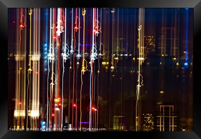 City life of dazzling lights and colors Framed Print by Andis Atvars
