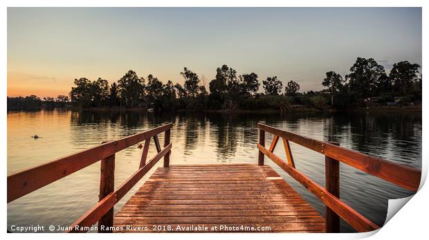 Reddish wooden pier over the lake with calm waters Print by Juan Ramón Ramos Rivero