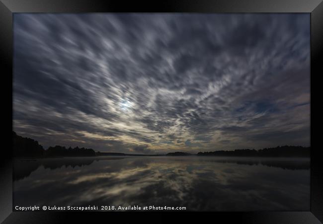 Dynamic clouds in the night over the lake lit by f Framed Print by Łukasz Szczepański