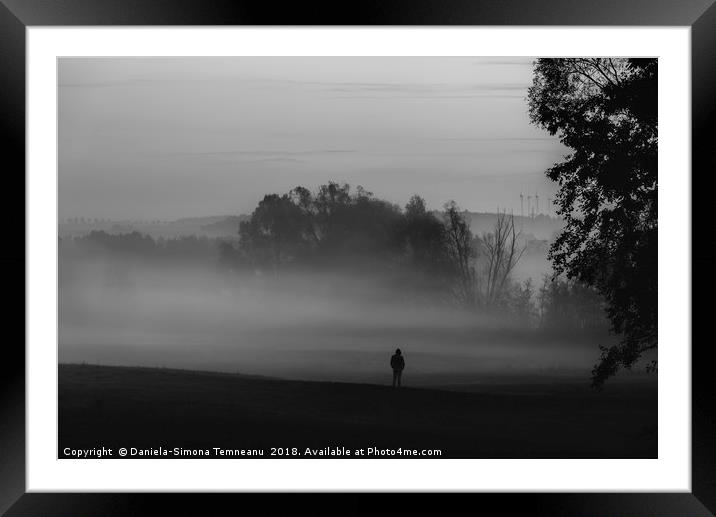 Man standing alone in darkness and fog Framed Mounted Print by Daniela Simona Temneanu