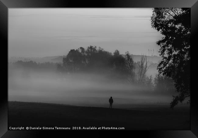 Man standing alone in darkness and fog Framed Print by Daniela Simona Temneanu