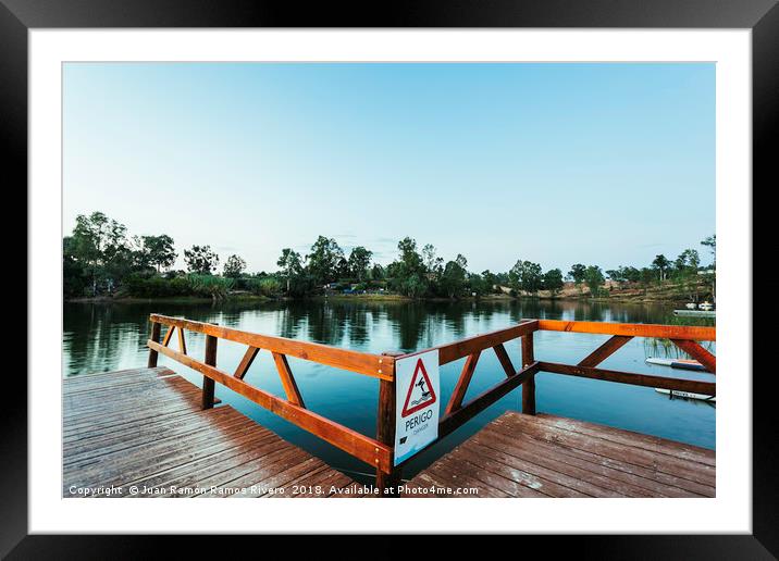 Wooden jetty with danger sign jumping into the wat Framed Mounted Print by Juan Ramón Ramos Rivero