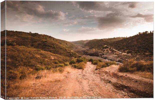Very steep dirt road that leads to the Guadiana Ri Canvas Print by Juan Ramón Ramos Rivero