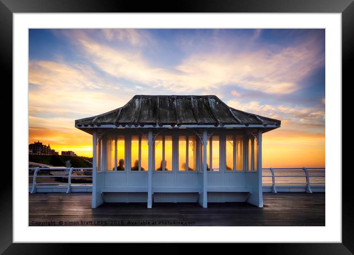 Cromer pier people watching sunset in Norfolk UK Framed Mounted Print by Simon Bratt LRPS